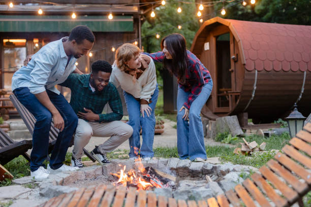 istock Friends gathering around bonfire, enjoying outdoor evening 2187089685