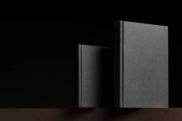 istock Black hardcover book or notepad mock up on black background 2187091473