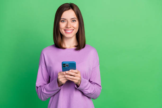 istock Photo of positive lady using modern technology enjoy web communication isolated on green color background 2187091615