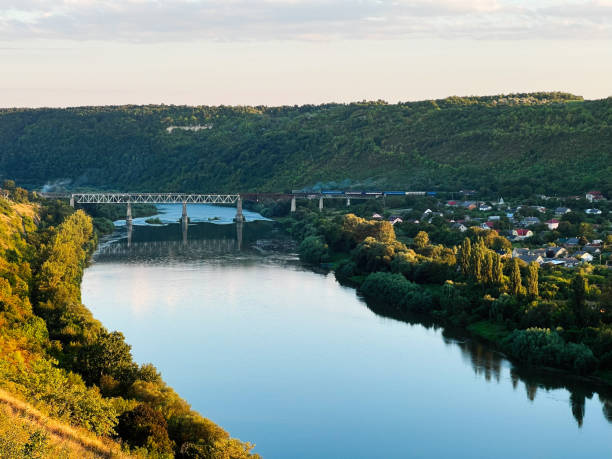 istock Peaceful river landscape with a bridge and tranquil village view 2187092212