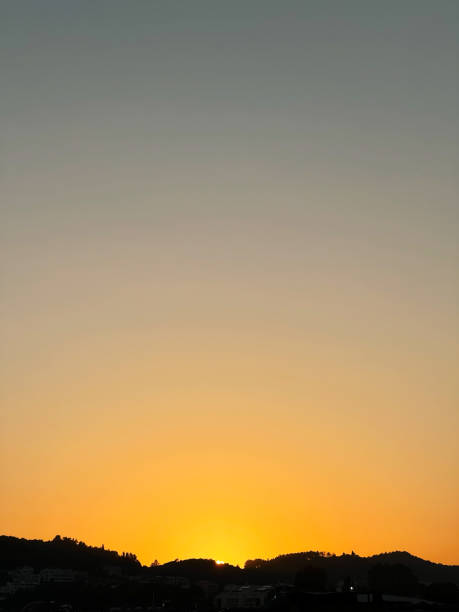 istock Golden sunrise over silhouetted hills under a clear sky 2187092371