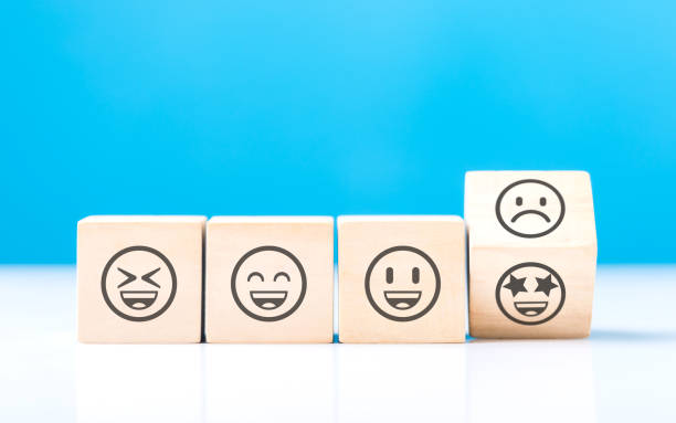 istock Wooden blocks displaying a sad face transitioning to a happy face, symbolizing a shift from negativity to positivity. Final block turns from sad to happy, highlighting the power of a positive outlook 2187092599