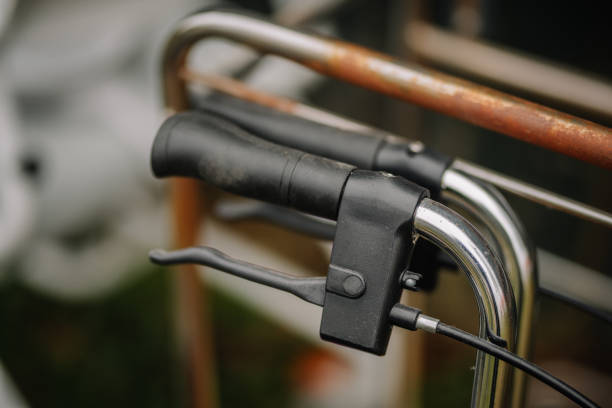 istock Close-up of a black handle and brake lever on a mobility aid with chrome frame, emphasizing details of assistive equipment for healthcare or elderly use. 2187092948