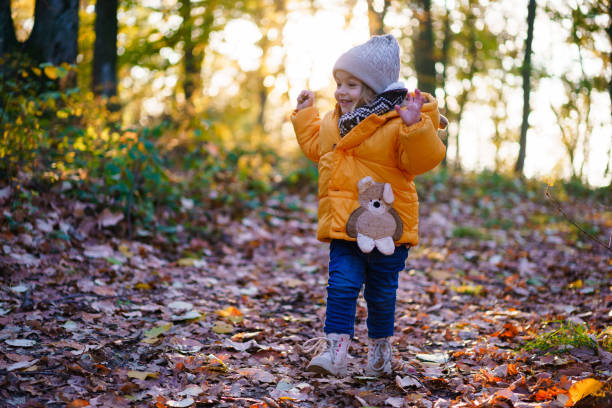 istock A happy girl is walking along a forest path 2187093066