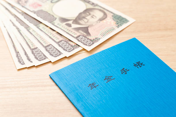 istock Pension book and money on a table 2187094118