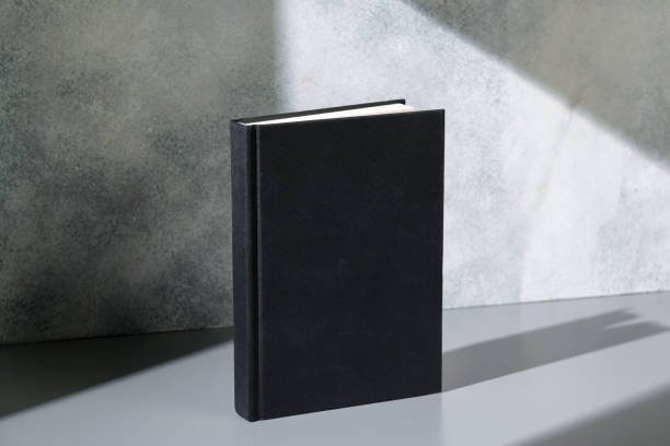 istock Black notepad with hard cover on gray background 2187095145