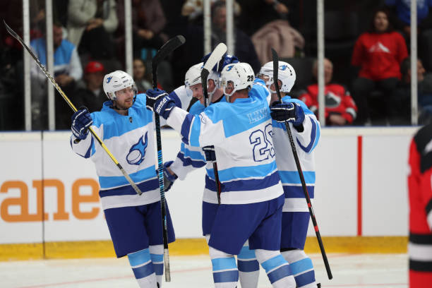 istock Blue Team Hockey Players Celebrating Together 2187096278