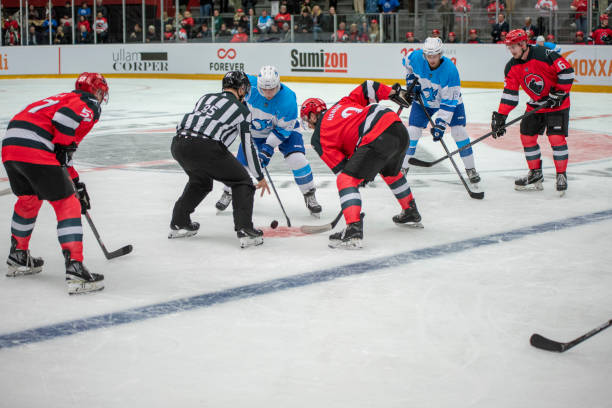 istock Ice Hockey Face-off Between Teams in Red and Blue Uniforms 2187096334