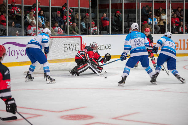 istock Ice Hockey Goalie Blocking a Shot During a Competitive Match 2187096337