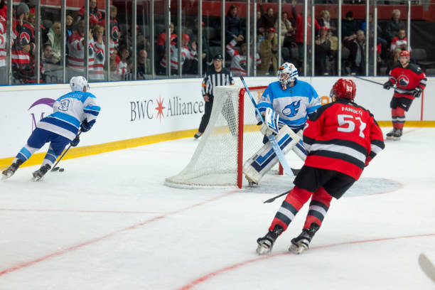 istock Defensive Stance: Goalie and Defenseman Protect the Net 2187096493