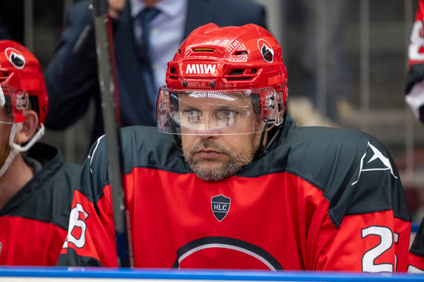 istock Focused Ice hockey Player Sitting on the Bench 2187096584
