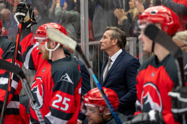 istock Hockey Coach Observing Game with Team on Bench 2187096594