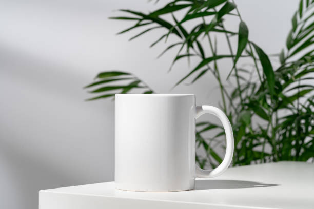 istock Porcelain cup and palm branch on white background 2187096888