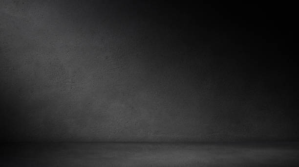 istock Empty concrete room in the dark with lighting for mock up 2187097444
