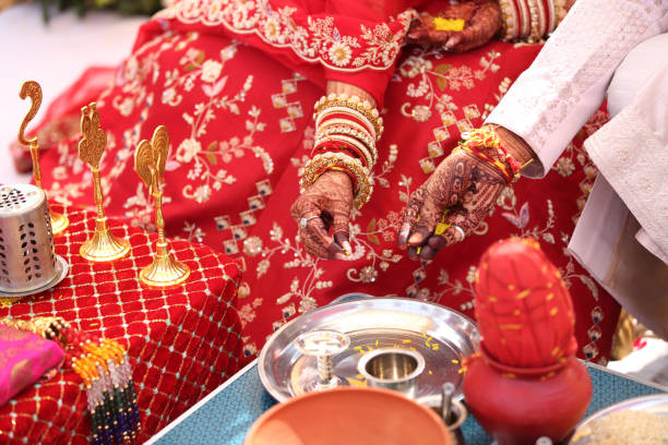 istock Offering prayers to the holy fire during a Hindu wedding ceremony. 2187101236
