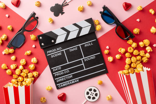 istock A flat lay featuring 3D glasses, clapperboard, popcorn, and heart-shaped chocolates, creating a cozy Valentine's Day movie night setting 2187102017