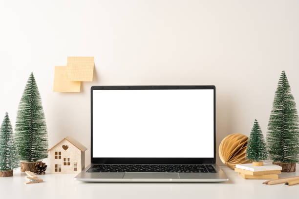 istock A still life minimalistic winter-themed desk setup featuring a laptop, small Christmas trees, and pinecone decorations, creating cozy Scandinavian-style atmosphere perfect for a productive workspace 2187102170