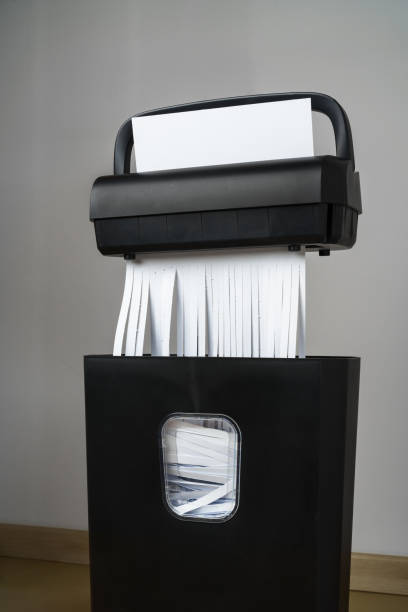 istock Black paper shredder cutting paper on gray background 2187102336