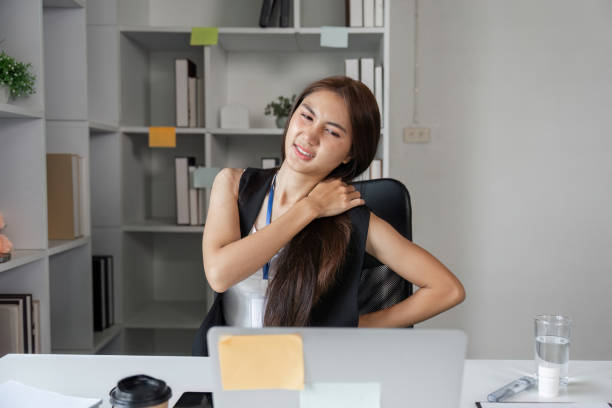 istock Exhausted Female Office Worker Struggling with Fatigue at Her Desk in a Modern Workplace Environment 2187102614
