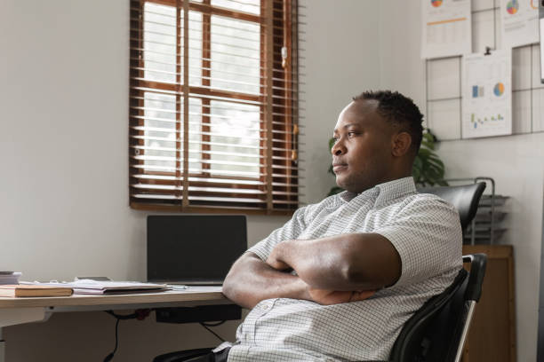 istock Stressed Male Office Worker Contemplating Solutions in a Modern Workplace Environment 2187102904
