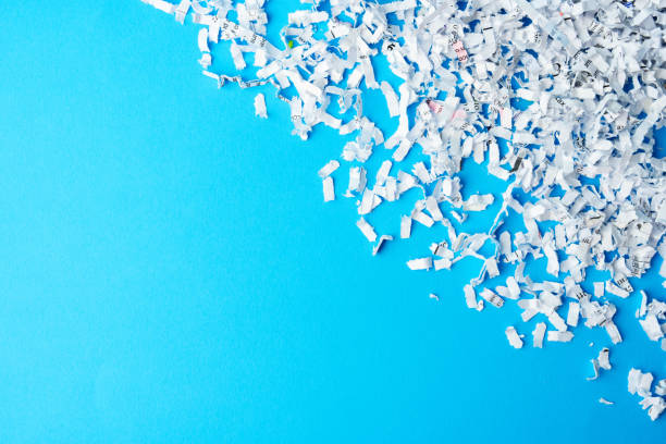 Shredded paper pieces on a blue background in studio