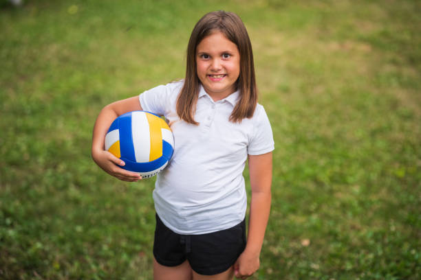 istock Young girl holding a volleyball 2187107481