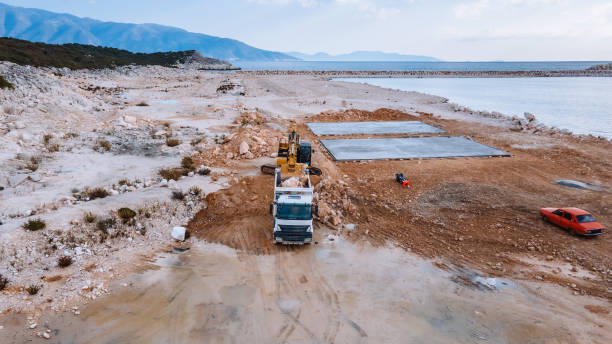 istock Coastal Construction Site with Heavy Machinery and Sea View 2187109355