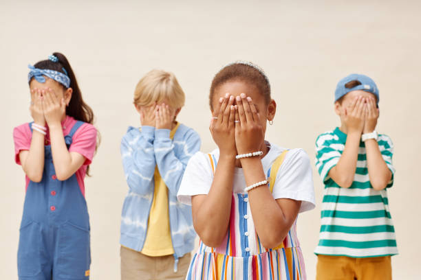 istock Four Afraid Preteen Children Covering Eyes with Hands in Studio 2187109706