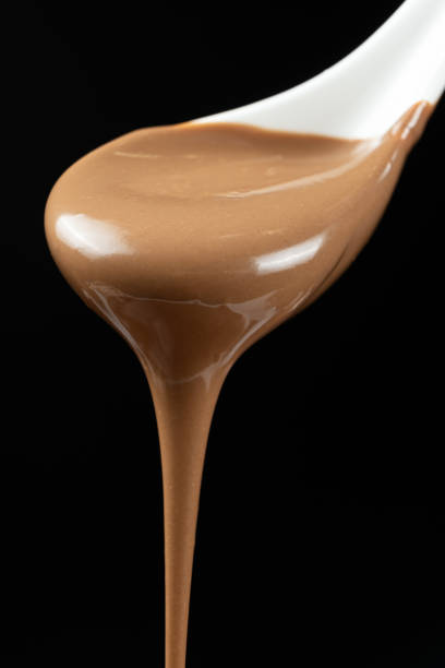 istock Melted milk chocolate poured out of a spoon. 2187110368
