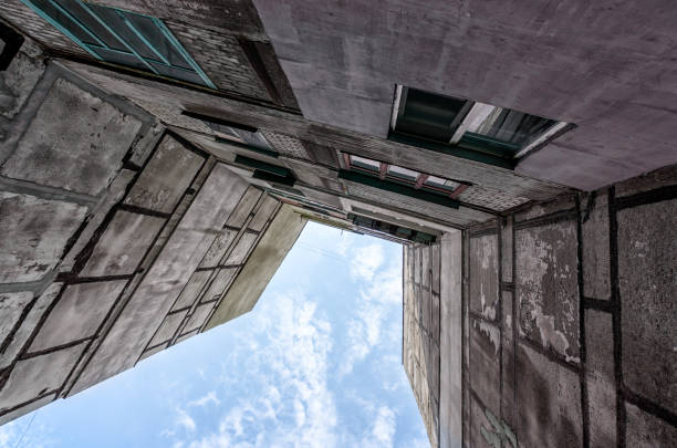 old gray tall building without people in Ukraine Donbass bottom view