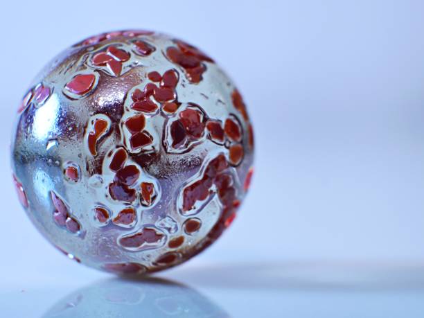 A closeup on a colorful and shiny marble on a white background