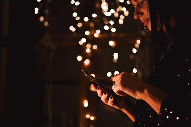 istock Woman using telephone at Christmas night. 2187113055