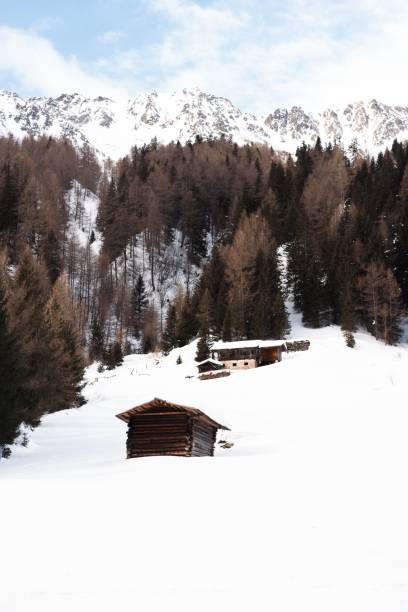 istock Scenic winter landscape with a wooden cabin 2187114604