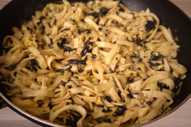 istock Omelette being cooked with tagliatelle pasta and black trumpet mushrooms 2187114622