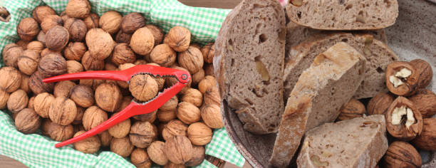 istock Sliced ​​Walnut Bread Loaf  Basket with Heaped Walnuts 2187114819