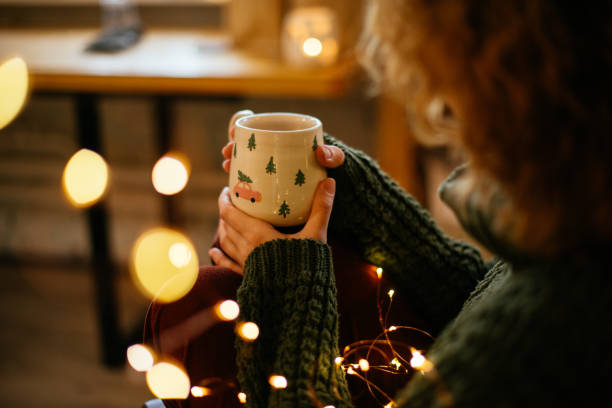 Christmas-themed mug in gentle hands, creating a cozy and nostalgic Xmas