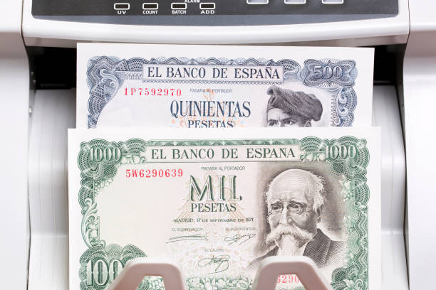 istock Old Spanish peseta in the counting machine 2187116697