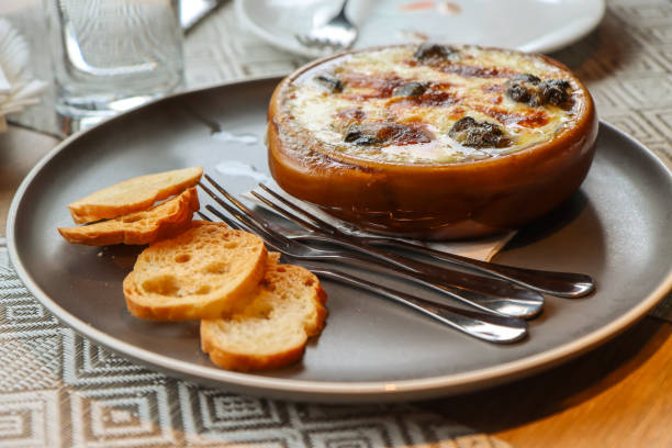 istock Baked escargot in cheese served with toasted bread slices 2187119063