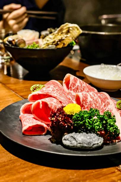 Marbled Beef Slices on Display with Vibrant Garnish