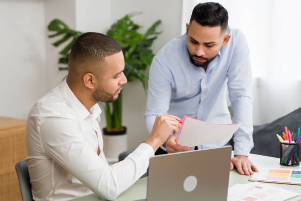 istock Two businessmen reviewing documents together in office 2187121462