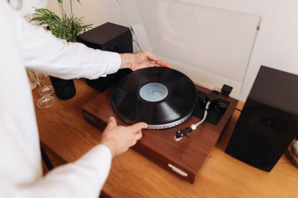 istock The unrecognisable man puts a vinyl record on the record player at home 2187122044