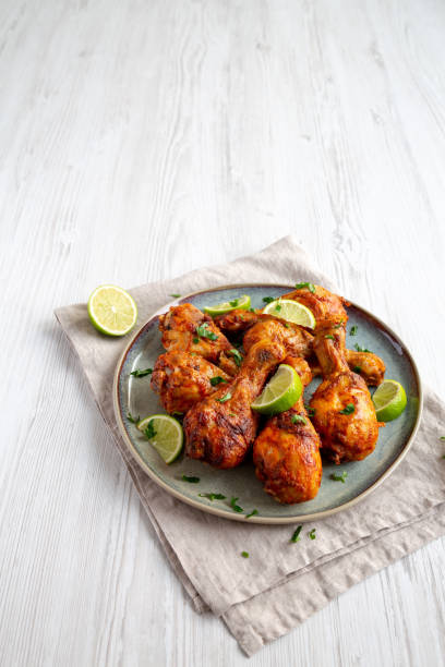 istock Homemade Grilled Jerk Chicken with Lime on a Plate, side view. Space for text. 2187125722