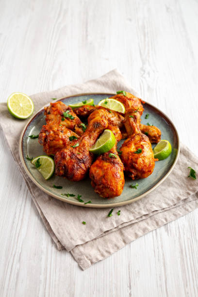 istock Homemade Grilled Jerk Chicken with Lime on a Plate, side view. 2187125798