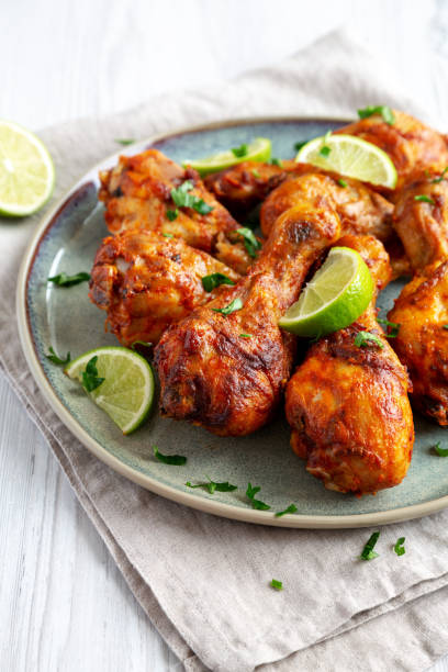 istock Homemade Grilled Jerk Chicken with Lime on a Plate, side view. 2187125828