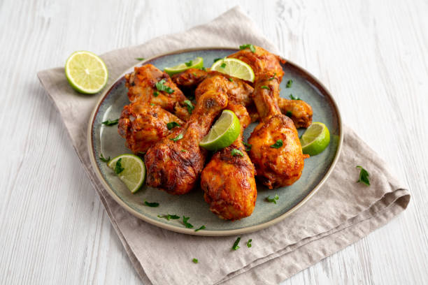 istock Homemade Grilled Jerk Chicken with Lime on a Plate, side view. 2187125868