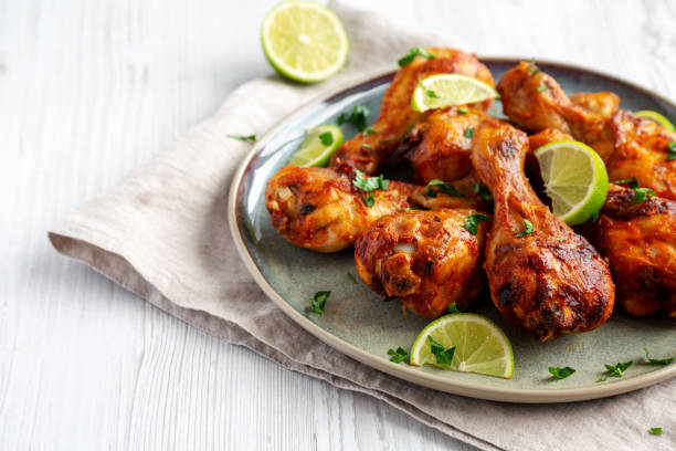 istock Homemade Grilled Jerk Chicken with Lime on a Plate, low angle view. Copy space. 2187125953