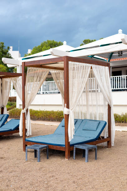 istock Relaxing beachside cabanas with elegant drapes near a resort in summer 2187127500