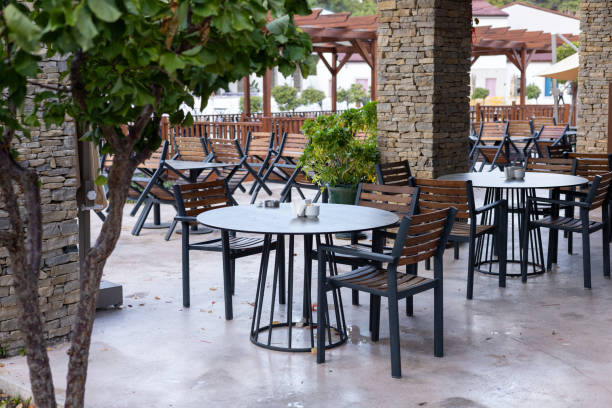 istock Outdoor dining area with empty tables nestled under rustic architecture 2187127691