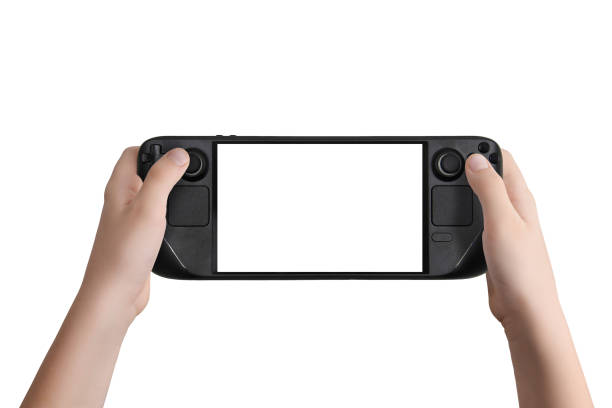 istock Flat lay or front view of hands holding a black handheld gaming console with isolated screen and background, perfect for mockup designs and technology presentations 2187127823