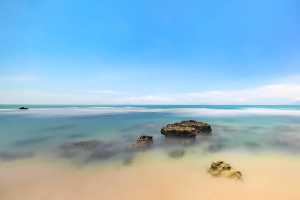 Smooth Ocean Waves Under a Vibrant Sky. Serene Ocean View with Gentle Waves.